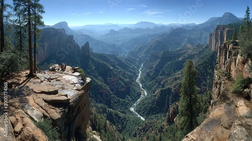 Hikers at Scenic Cliff Overlook, Deep River Canyon with Pine Forests and Layered Mountain Range, Bright Sunny Wilderness Landscape