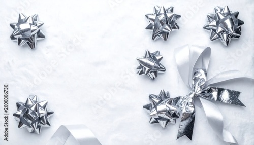 Elegant Silver Gift Bows and Ribbon Arrangement on White Marble Surface.