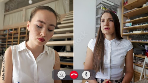 Two students engage in focused conversation. One writes notes while the other listens intently. They share insights on a topic in a virtual setting.