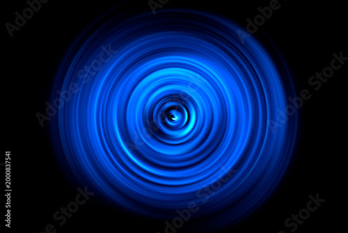 Abstract blue neon circles on a black background.