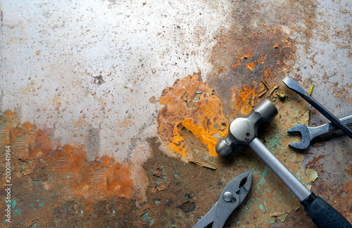 Rusty metal background with hand tools for repair and industrial concept