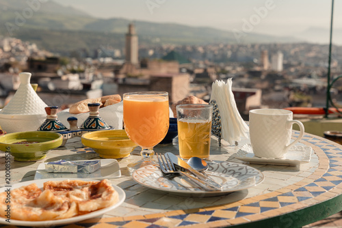 Schilderij op canvas Moroccan breakfast on a rooftop terrace overlooking the ancient Fes Medina with