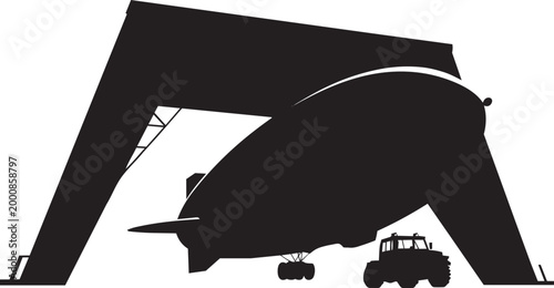 Blimp and tractor inside a large industrial hangar structure for aerospace logistics and storage