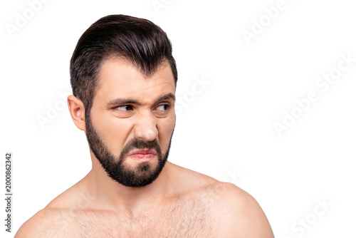 Konstfotografi Close up portrait of emotional man with dislike emotion on his face, looking to