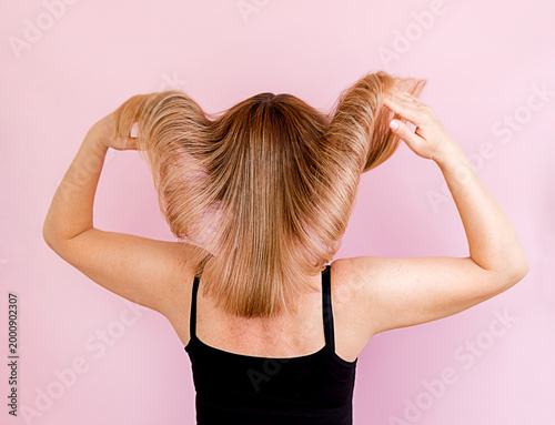 a woman spreads her healthy, clean, beautiful, and silky hair