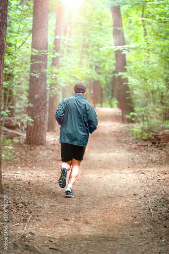 a man jogging in a spring forest