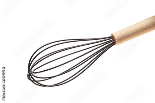 Fotografie Metal kitchen whisk with ergonomic wooden handle isolated on light background