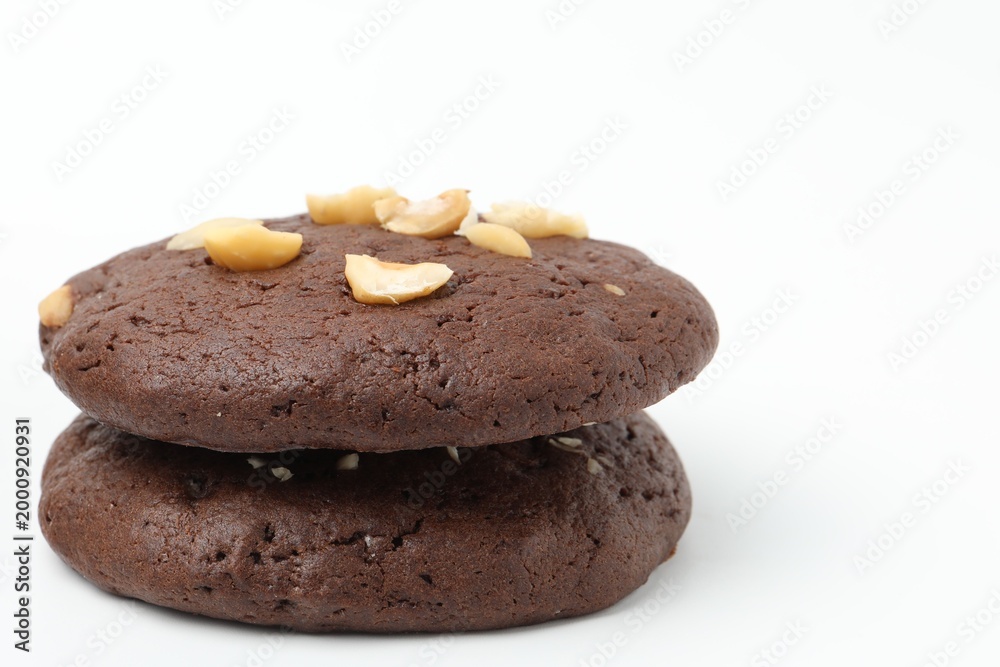 Fototapeta premium Tasty chocolate cookies with hazelnuts isolated on white