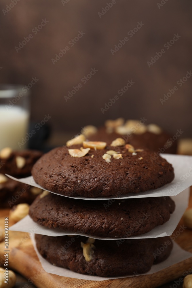 Fototapeta premium Tasty chocolate cookies with hazelnuts on table, closeup