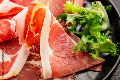 Jamоn exquisite cured meat sliced meat dish tasty snack fresh, delicious, gourmet food background on the table, rustic food, top view, copy space