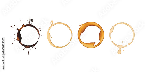 Set of four coffee cup ring stains and liquid splatters on a flat surface