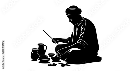 Silhouette of a traditional artisan craftsman decorating ceramic pottery
