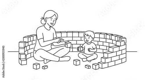 A mother playing with her young son building a wall of blocks together.