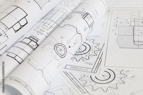 paper engineering drawings of industrial parts and mechanisms