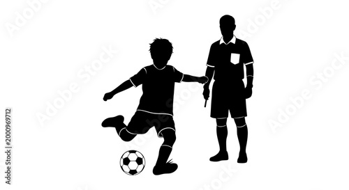 Black silhouette of a young soccer player kicking a ball with a referee standing nearby.