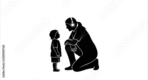 Silhouette of an adult woman with headphones kneeling to talk to a small child.