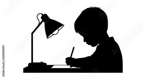 Silhouette of a young boy studying and writing at a desk with a lamp.