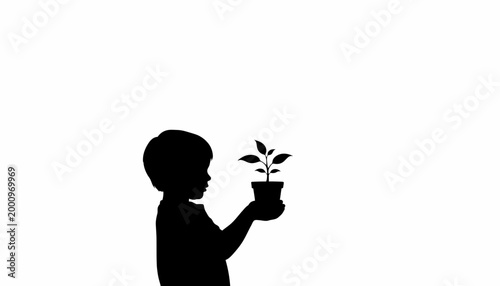 Silhouette of a young child holding a small potted plant in hands.