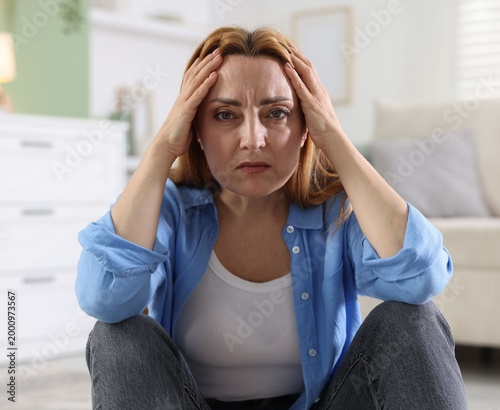 Tableau sur toile Menopause. Woman suffering from headache at home