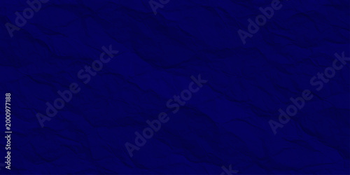 Dark navy blue crumpled paper texture, abstract wrinkled midnight fabric background, deep indigo textured relief surface. dark blue abstract background featuring deep wrinkles and folds.