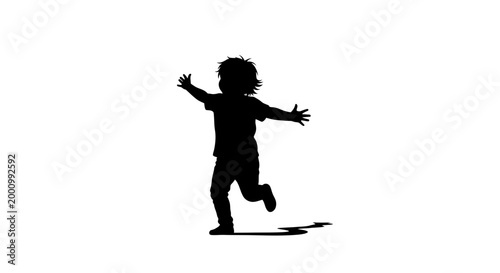 Silhouette of a happy young child running and playing.