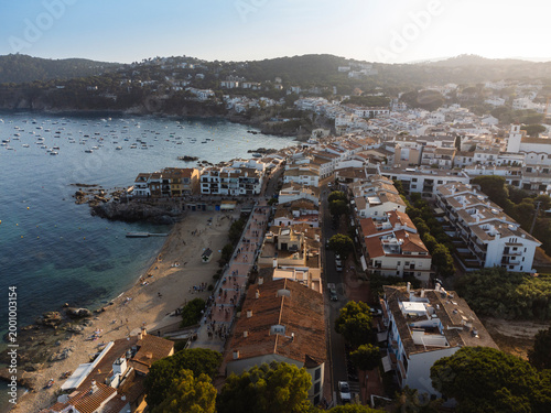 Aerial View of Mediterranean Coastal Town with Beach and Boats at Sunset