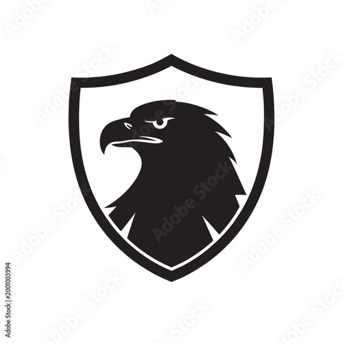 Eagle head logo inside a shield, black and white vector illustration of a powerful bird of prey profile for sports team or security company branding