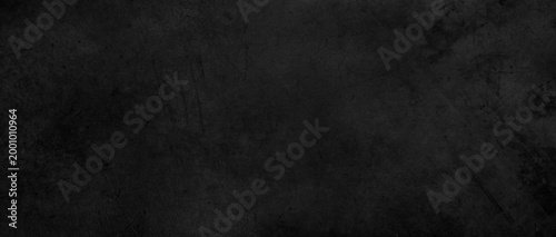 Dark grey textured concrete wall black background
