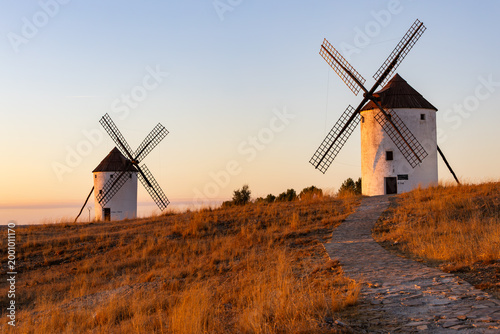 Spanish windmills dotting La Mancha landscape at sunset