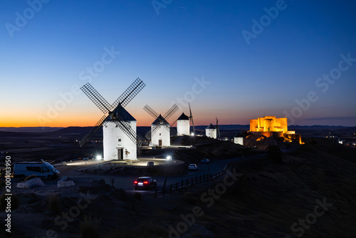 Consuegra windmills and castle illuminating twilight in La Mancha