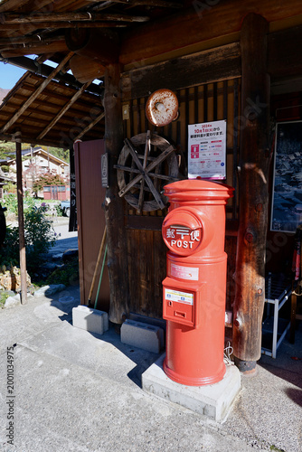 Tableau sur toile Red Round Post Box Outside Traditional Japanese Wooden Shop Front in Rural Japan