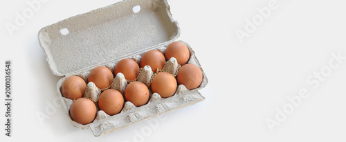 Expensive eggs. Eggs in an open cardboard box, a gold chain on top. Conceptual image, rising food prices, inflation, economic crisis
