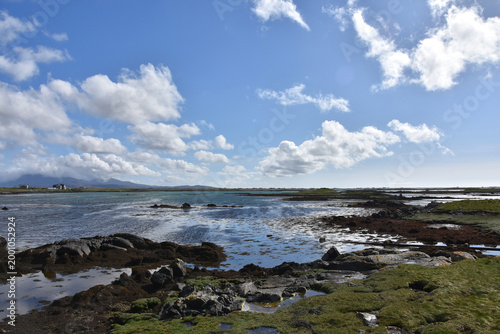 Shallow Cove Waters with Fluffy White Clouds