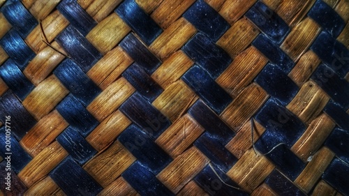Fotografie A natural brown wicker basket weave pattern creates a textured bamboo and straw