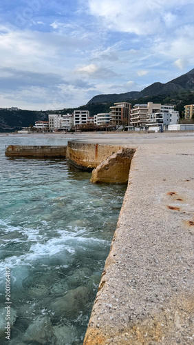 Dobra Voda waterfront along Adriatic Sea with concrete pier and coastal buildings