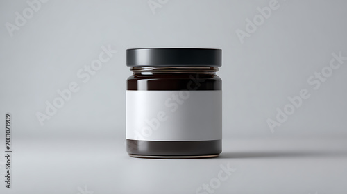 Minimalist Transparent Glass Jar with Blank White Label and Black Lid on a Clean White Surface for Product Mockup Design