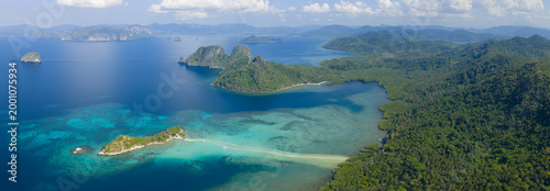 A sinuous sand bank stretches out from Snake Island in Bacuit Bay near El Nido, Philippines. This idyllic spot is a popular tourist destination and is a wonderful place to swim.