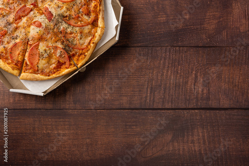 Foto Pizza in a takeout box for football championship game night on a rustic wooden t