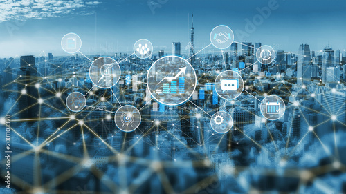 Bild auf Leinwand Abstract digital network connecting city skyline with business icons representin