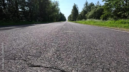 Video shooting in motion, driving a red car over the road along the asphalt at speed, view from the wheel.