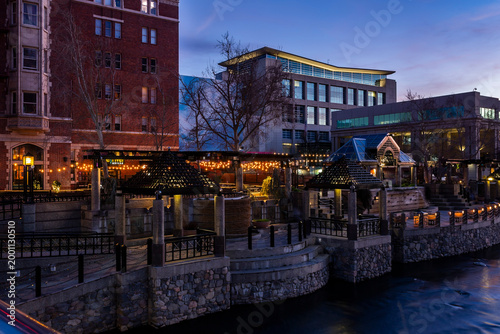 Bild auf Leinwand Illuminated riverwalk in the downtown in dusk in Reno, Nevada