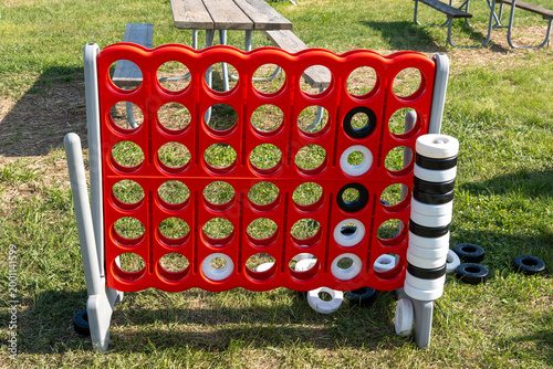 Outdoor “4 in a Row” plastic game set on a field, classic American-style children’s activity, colorful and fun, perfect for family play, lawn games and summer events