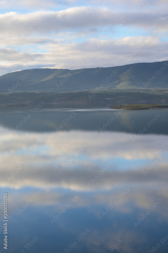 Fototapeta premium Cloud reflections over mountain lake
