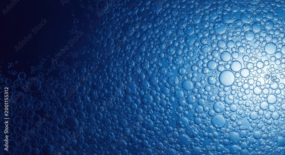 Obraz premium Closeup of blue bubbles on a wet surface with light reflection water