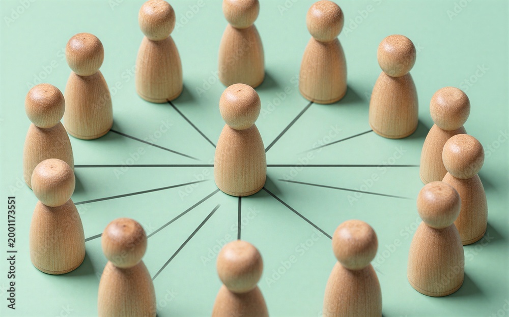 Obraz premium Wooden figures form a circle connected by lines to one central figure.