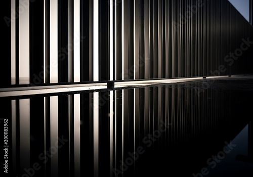 Abstract Modern Architecture with Vertical Slats and Reflection on Wet Surface