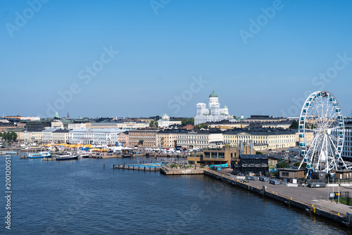 Helsinki, Finland harbor viewed from the water with buildings and ferris wheel