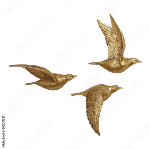 Three golden birds fly in formation through clear sky