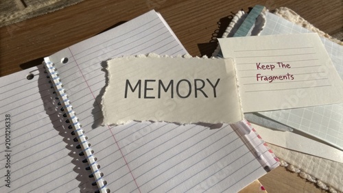 A Close-Up of Torn Paper with the Word Memory Surrounded by Note Cards and Blank Notebooks, Symbolizing Reflection and Nostalgia in Daily Life