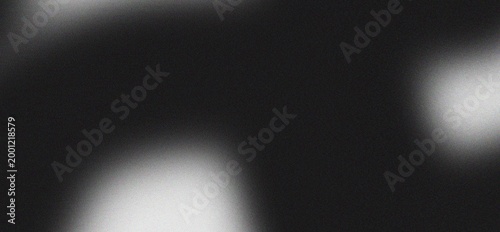 Abstract grainy texture with blurred light effects creating a dark moody background for graphic design purposes